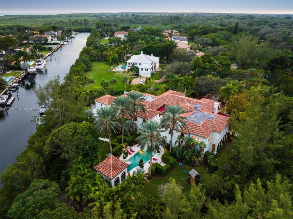 Aerial view of luxury home with private backyard dock
